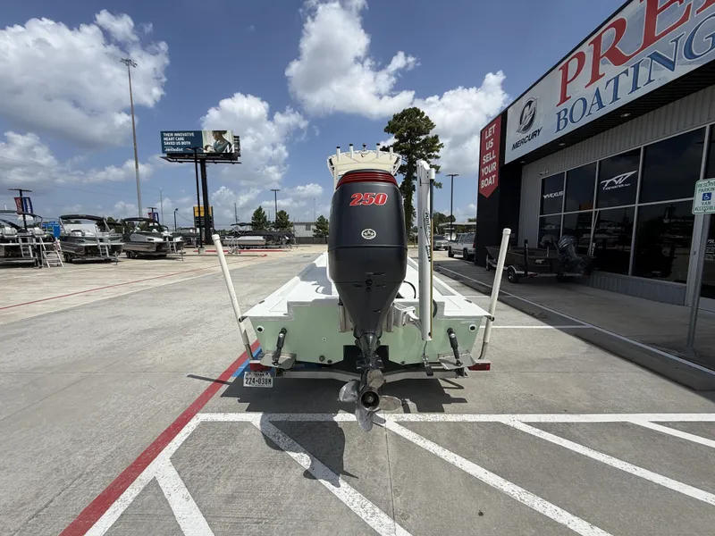 Slide: The Image of A 2015 Mowdy C-25 boat is parked outside a boating sales shop. - 9