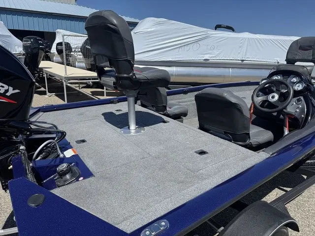 Slide: The Image of A 2021 Tracker Pro Team 175 TF boat with gray carpeted deck and black helm. - 11