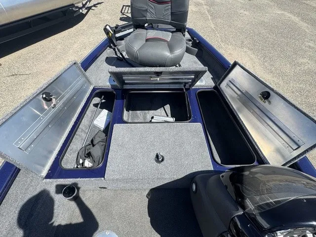 Slide: The Image of The image shows the deck of a 2021 Tracker Pro Team 175 TF boat with multiple storage compartments. - 25