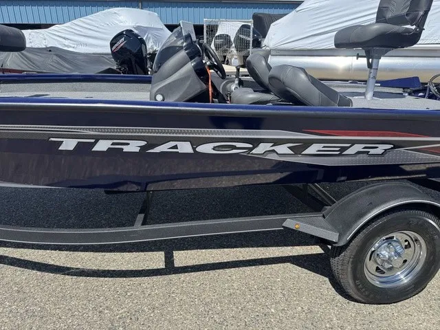 Slide: The Image of A 2021 Tracker Pro Team 175 TF boat on a trailer, featuring an outboard motor. - 37