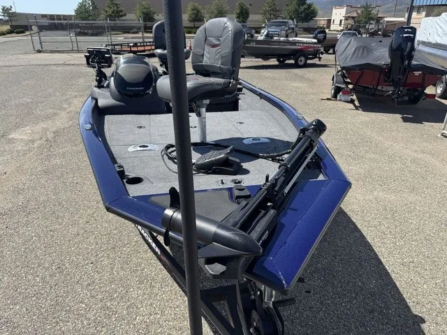 Slide: The Image of A 2021 Tracker Pro Team 175 TF boat with a gray deck and blue accents, parked on a trailer. - 19
