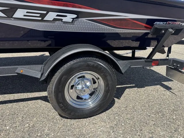 Slide: The Image of Close-up of a boat trailer with a shiny wheel and part of the boat hull. - 38