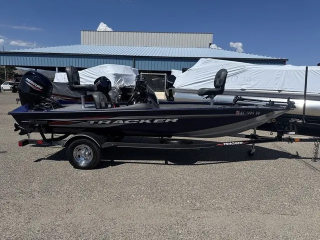 The Image of A 2021 Tracker Pro Team 175 TF boat on a trailer in a parking lot. - 1