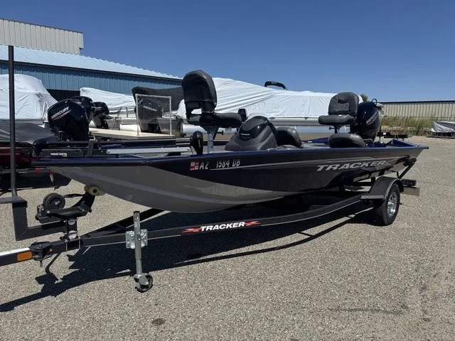 Slide: The Image of A 2021 Tracker Pro Team 175 TF boat on a trailer, parked on an asphalt lot. - 34