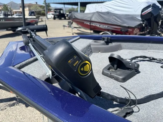 Slide: The Image of Close-up of a blue Tracker Pro Team 175 TF boat with a motor and gray deck. - 36