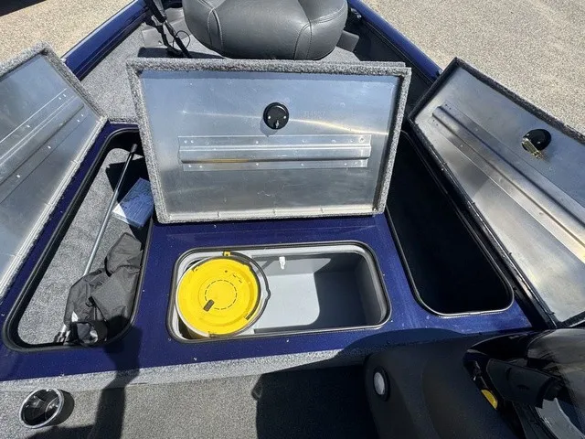Slide: The Image of The image shows the storage area of a 2021 Tracker Pro Team 175 TF boat with open compartments. - 26