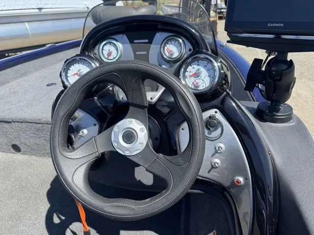 Slide: The Image of The image shows the cockpit of a 2021 Tracker Pro Team 175 TF boat. It features a modern dashboard with multiple gauges and a steering wheel. - 14