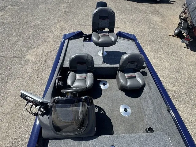 Slide: The Image of The image shows the cockpit of a 2021 Tracker Pro Team 175 TF boat with gray seats. - 22