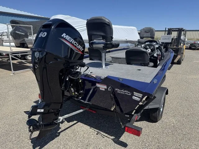 Slide: The Image of A 2021 Tracker Pro Team 175 TF boat with a Mercury 50 HP outboard motor, parked on a trailer. - 6