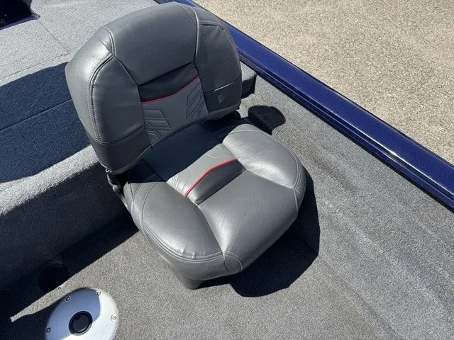 Slide: The Image of A gray, cushioned seat on a carpeted boat deck. - 28