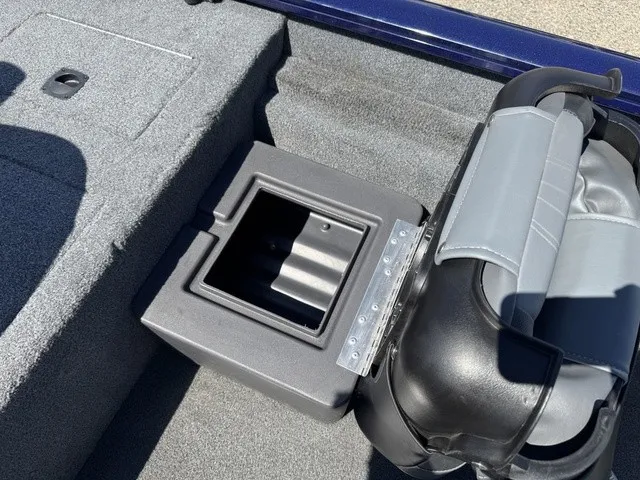 Slide: The Image of A gray padded seat on a boat with an open storage compartment beside it. - 30