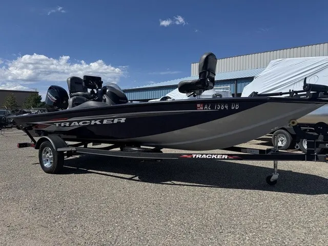Slide: The Image of A 2021 Tracker Pro Team 175 TF boat on a trailer in a parking lot. - 3