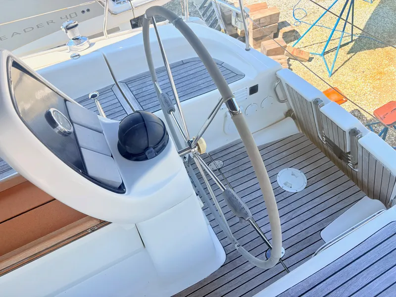 Slide: The Image of The image shows the cockpit of a 2008 Bavaria Cruiser 38 with a large steering wheel. - 7