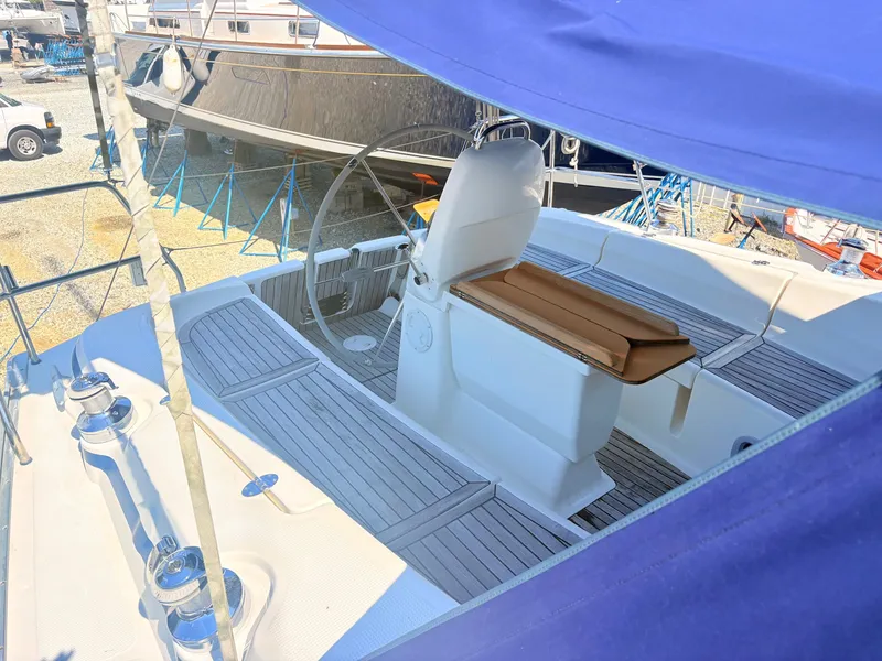 Slide: The Image of The image shows the cockpit of a 2008 Bavaria Cruiser 38 with a steering wheel and seating area. - 6