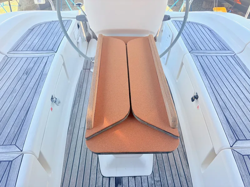 Slide: The Image of The cockpit of a 2008 Bavaria Cruiser 38 with a wooden table and gray seating areas. - 10
