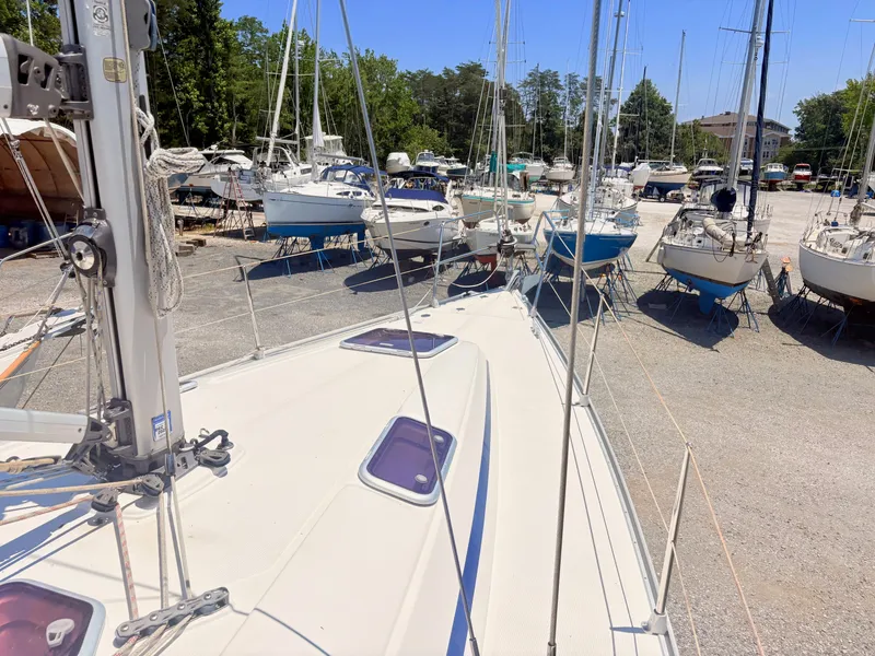 Slide: The Image of The deck of a 2008 Bavaria Cruiser 38, surrounded by other boats in a marina. - 15