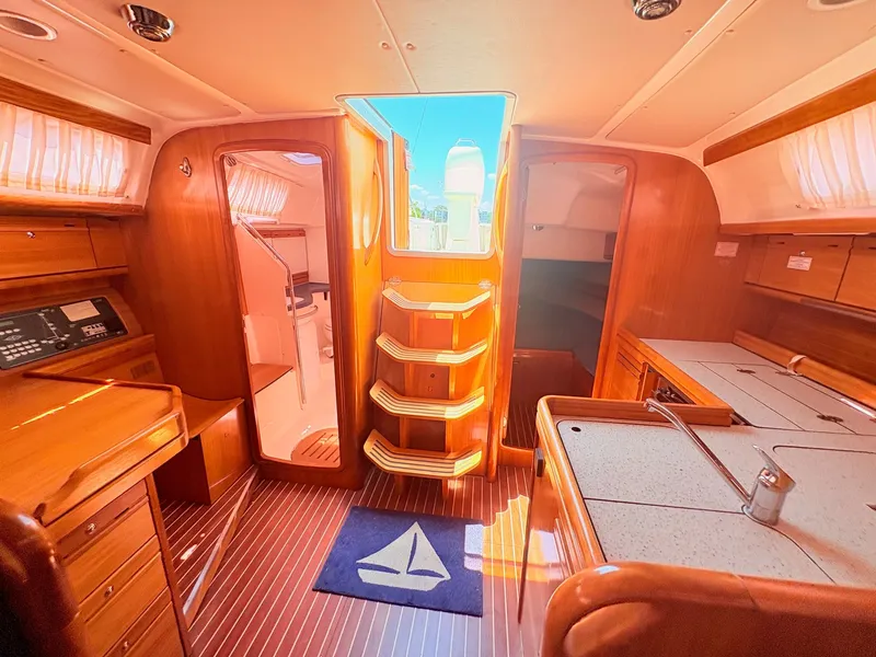Slide: The Image of Interior of a 2008 Bavaria Cruiser 38 with wood finish and stairs leading to the deck. - 37