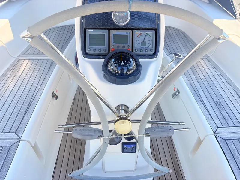 Slide: The Image of The cockpit of a 2008 Bavaria Cruiser 38 with a modern helm and instruments. - 8