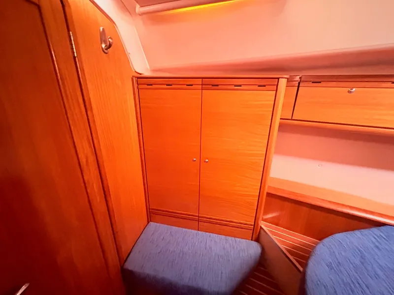 Slide: The Image of Interior of a 2008 Bavaria Cruiser 38 with wooden cabinets and blue upholstery. - 35