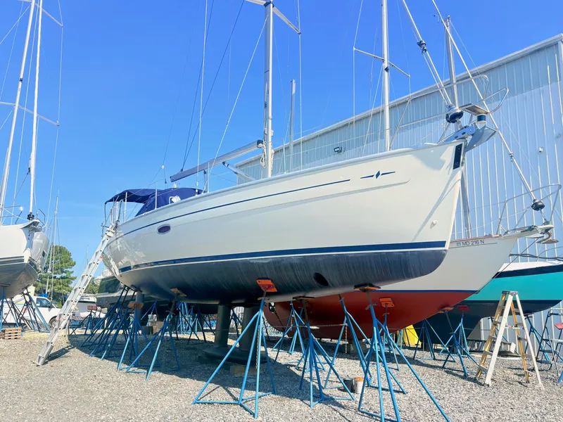 Slide: The Image of A 2008 Bavaria Cruiser 38 is propped up on stands in a boatyard. - 5