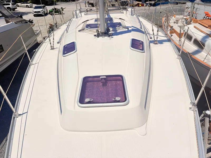 Slide: The Image of The deck of a 2008 Bavaria Cruiser 38 with multiple hatches and a mast. - 17