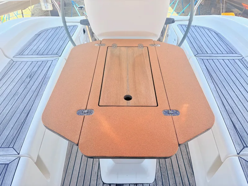 Slide: The Image of The cockpit area of a 2008 Bavaria Cruiser 38 with a foldable wooden table. - 11