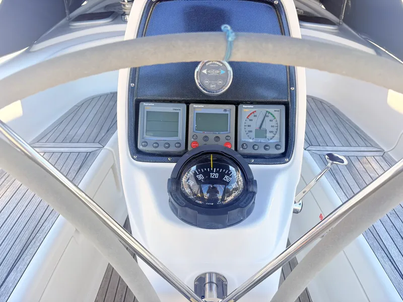 Slide: The Image of The image shows the helm of a 2008 Bavaria Cruiser 38 with instruments and a compass. - 9