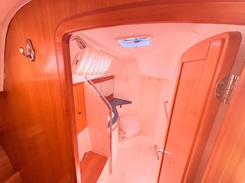 Slide: The Image of Interior view of a 2008 Bavaria Cruiser 38's head with wooden paneling. - 21