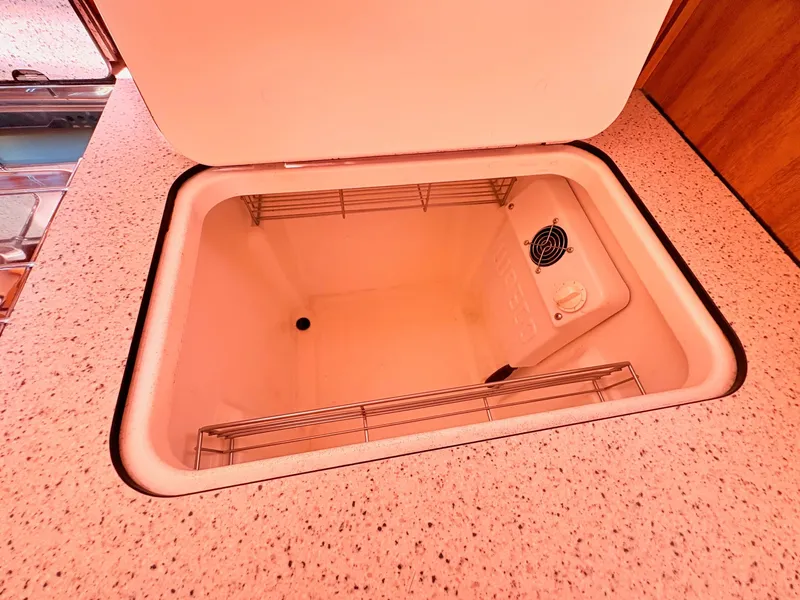 Slide: The Image of An open fridge or storage compartment inside a 2008 Bavaria Cruiser 38. - 28