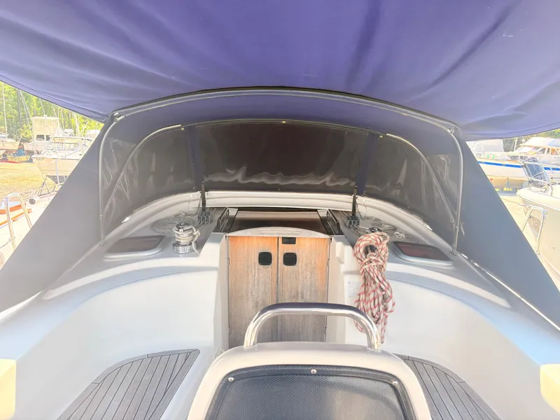 Slide: The Image of The image shows the cockpit of a 2008 Bavaria Cruiser 38 with a blue cover. - 18
