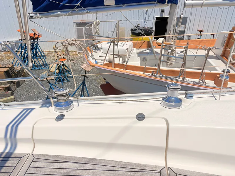 Slide: The Image of The image shows the deck of a 2008 Bavaria Cruiser 38 with winches and railing. - 12