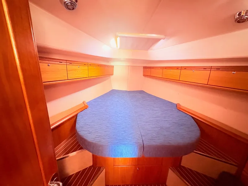 Slide: The Image of Cabin of the 2008 Bavaria Cruiser 38 with a double bed and wooden cabinets. - 32