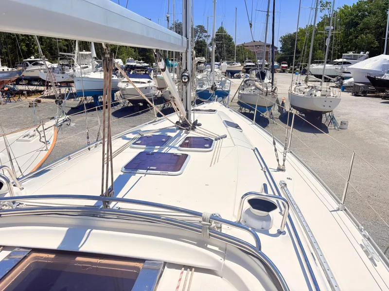 Slide: The Image of The deck of a 2008 Bavaria Cruiser 38, surrounded by other boats in the marina. - 14