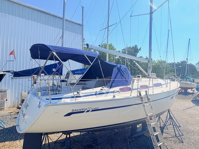 The Image of A 2008 Bavaria Cruiser 38 on a dry dock with blue covers. - 0