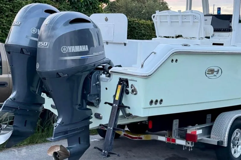 Slide: The Image of 2018 Sea Hunt Gamefish 25 boat with dual Yamaha 150 outboard motors on a trailer. - 14