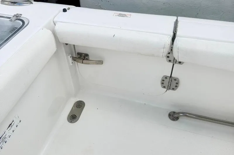Slide: The Image of 2018 Sea Hunt Gamefish 25 boat interior with white seating and stainless steel fixtures. - 12