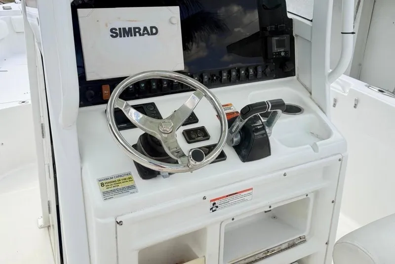 Slide: The Image of 2018 Sea Hunt Gamefish 25 helm with Simrad display and steering wheel. - 6