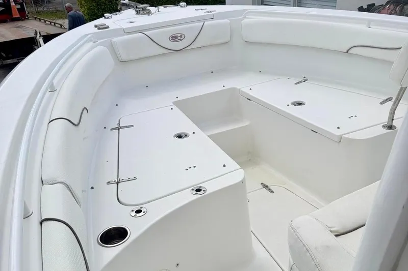 Slide: The Image of 2018 Sea Hunt Gamefish 25 boat interior with white seating and storage compartments. - 4