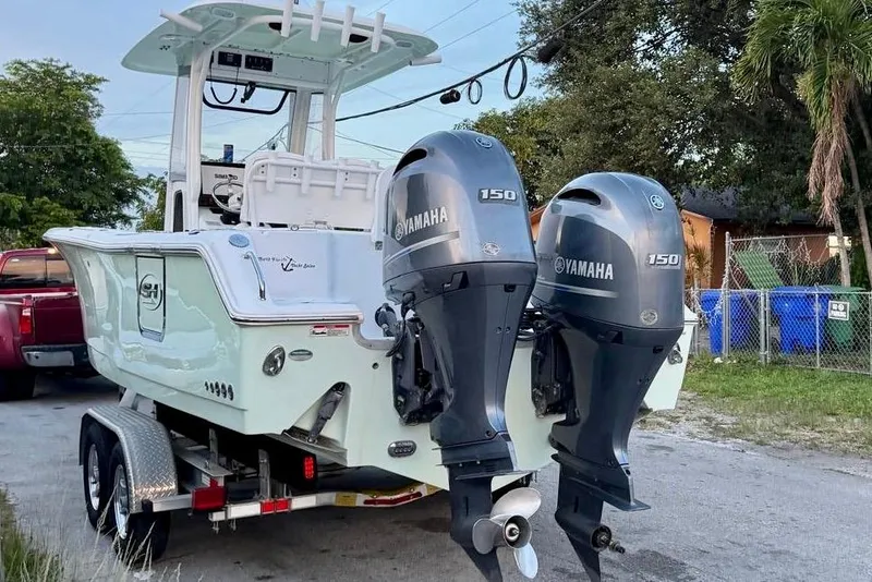 Slide: The Image of 2018 Sea Hunt Gamefish 25 boat with dual Yamaha 150 engines on a trailer. - 15