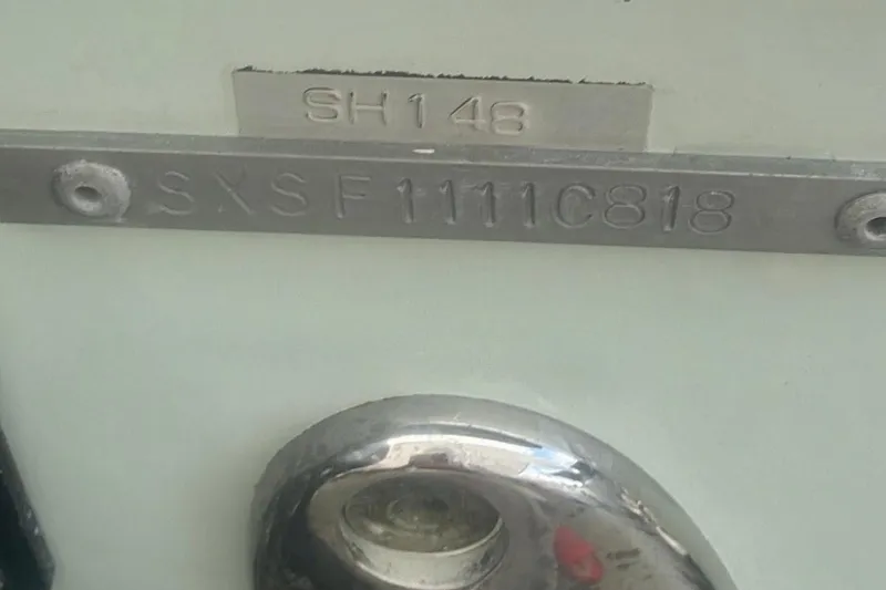 Slide: The Image of 2018 Sea Hunt Gamefish 25 hull identification number plate, displaying "SXSF1111C818". - 18