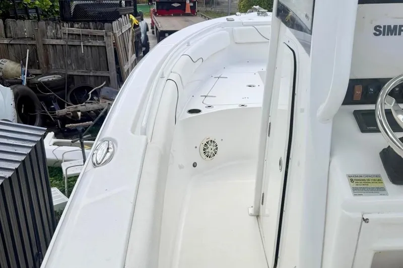 Slide: The Image of 2018 Sea Hunt Gamefish 25 boat interior with steering console and seating area. - 11