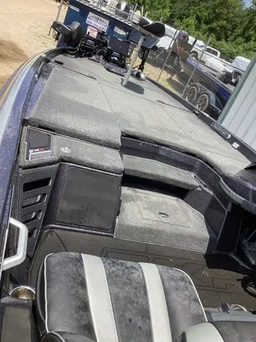 Slide: The Image of The image shows the deck of a 2023 Skeeter FXR21 boat with gray upholstery and a helm station. - 13