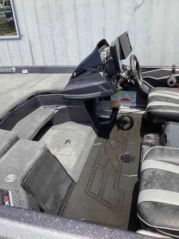 Slide: The Image of The image shows the cockpit of a 2023 Skeeter FXR21 boat with modern seating and a helm console. - 12