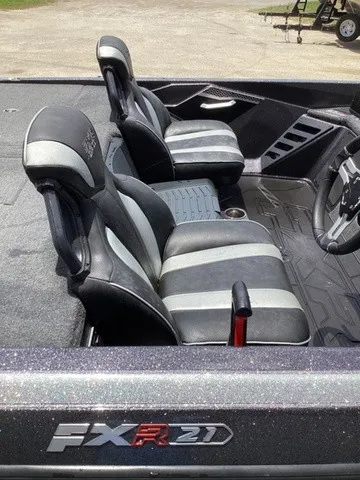 Slide: The Image of The image shows the interior of a 2023 Skeeter FXR21 boat with two cushioned seats. - 37