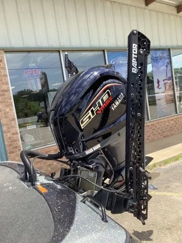 Slide: The Image of A Yamaha outboard motor is mounted on a boat parked in front of a building. - 9