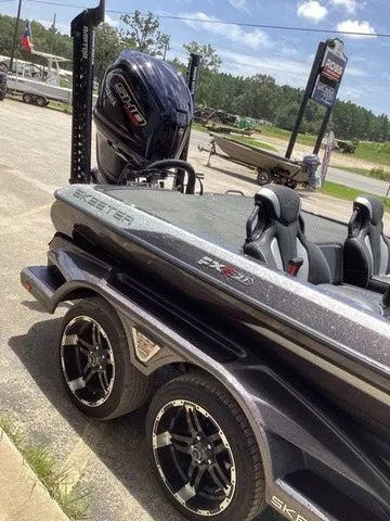 Slide: The Image of A 2023 Skeeter FXR21 boat on a trailer, featuring a powerful outboard motor. - 33