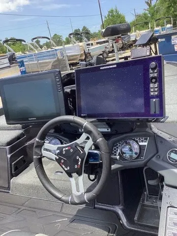 Slide: The Image of The image shows the cockpit of a 2023 Skeeter FXR21 with modern navigation systems and a stylish steering wheel. - 38