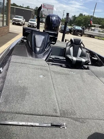 Slide: The Image of The image shows a modern 2023 Skeeter FXR21 boat with a gray deck and black seat. - 35