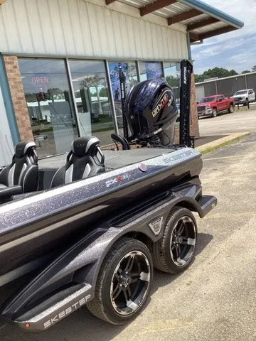 Slide: The Image of A 2023 Skeeter FXR21 boat on a trailer outside a building. - 14