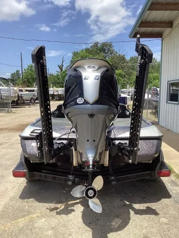 Slide: The Image of The image shows the rear of a 2023 Skeeter FXR21 boat with an outboard motor. - 3